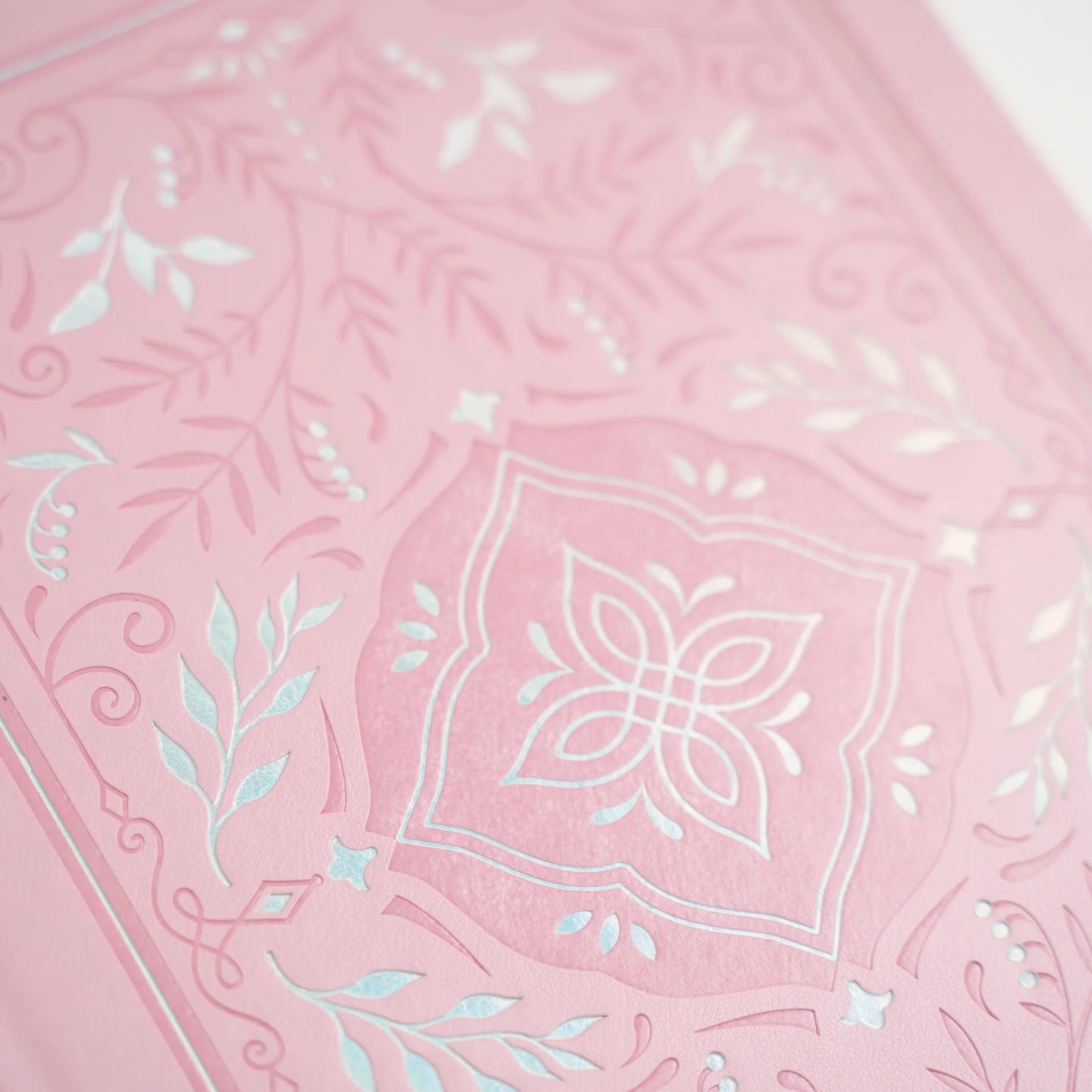 Archer and Olive Storybook in Pink Notebook with silver and pink debossed pattern. A soft delicate pattern that spans the full width of the cover. This image shows a close up of the pattern detail.