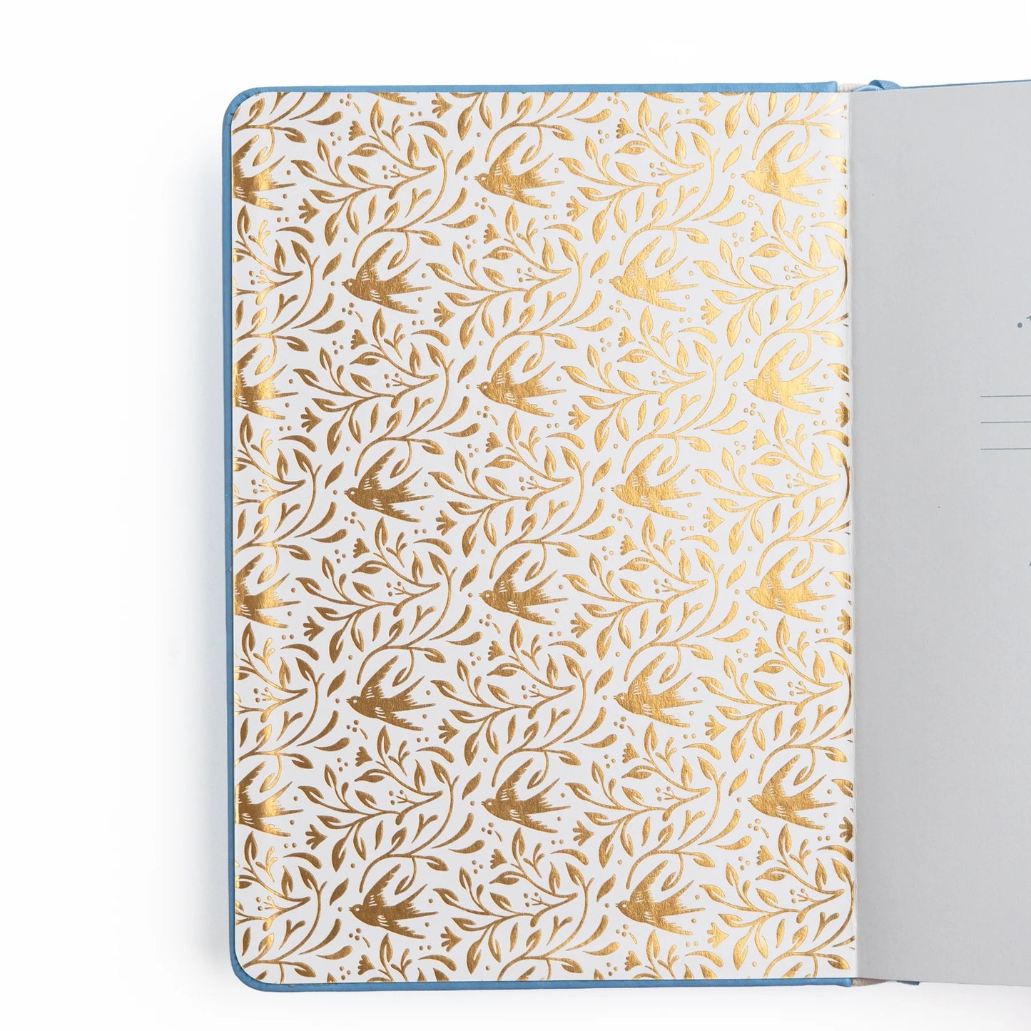 Interior cover of Notebook with gold floral pattern on white background