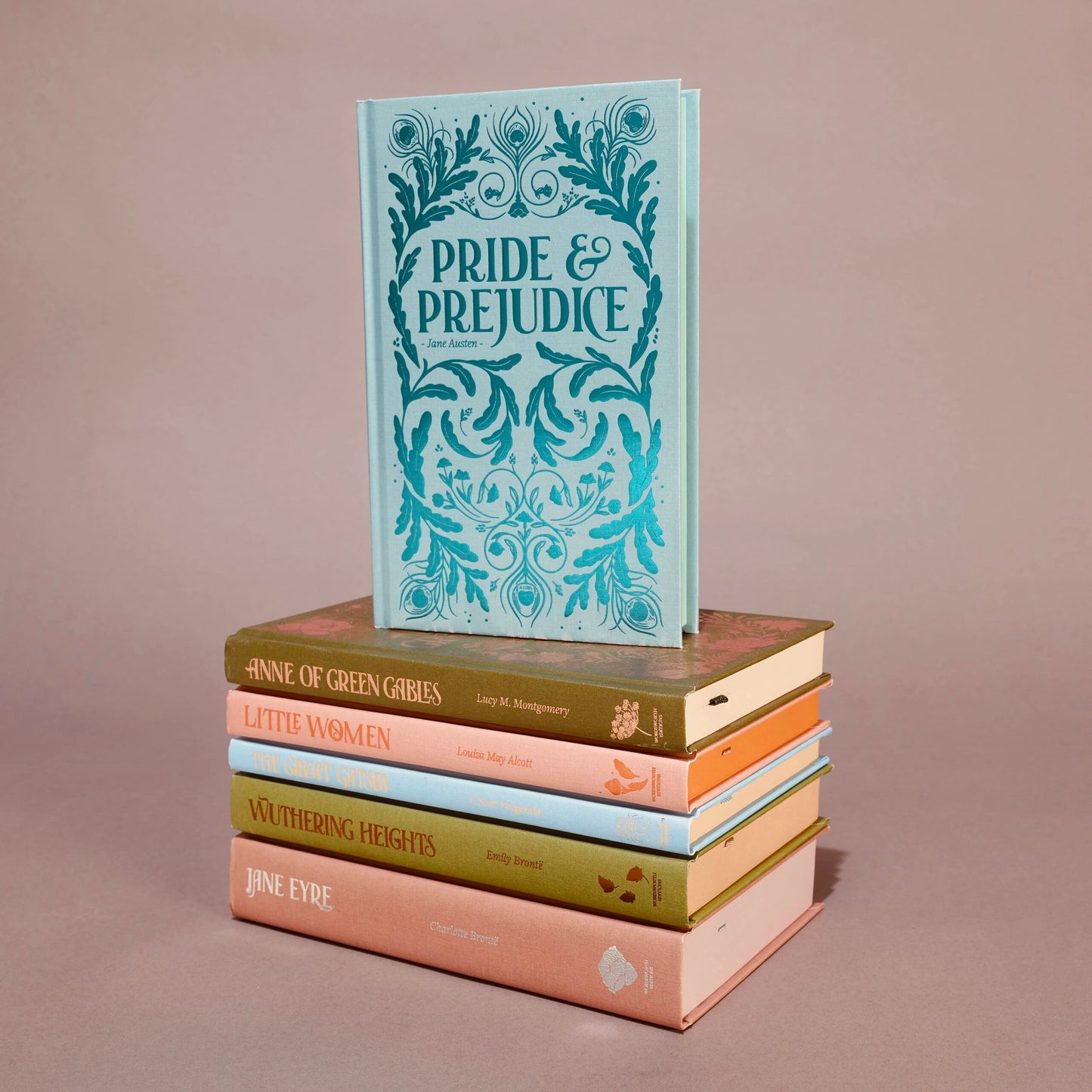 Stack of books with 'Pride & Prejudice' on top against a beige background