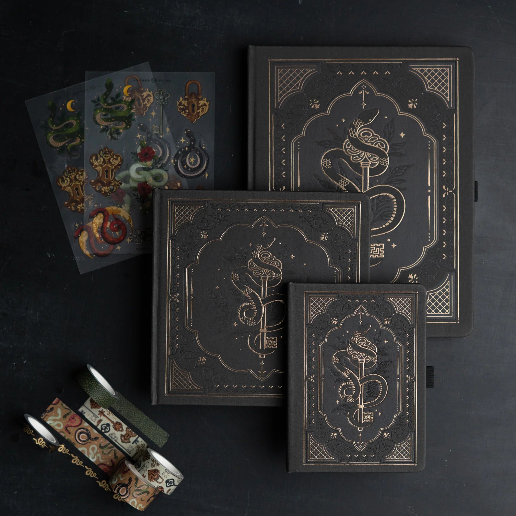 Decorative black boxes with intricate gold designs on a dark background