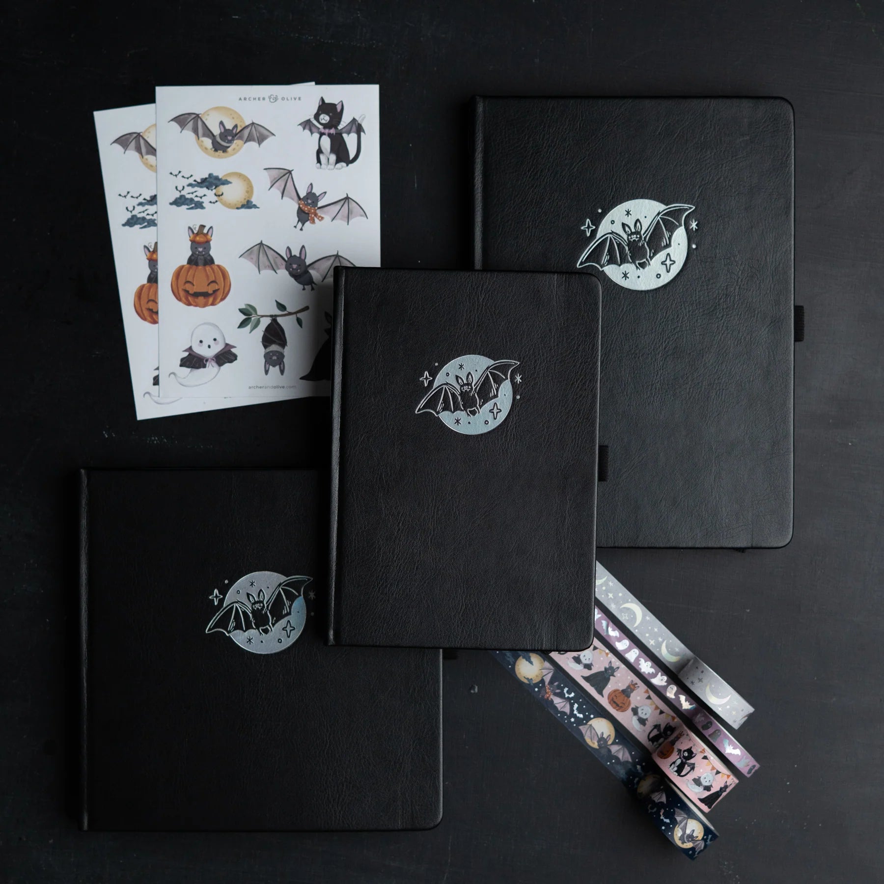 Archer and Olive Cute Bat - Black notebooks and sticker sheets with bat illustrations on a black background