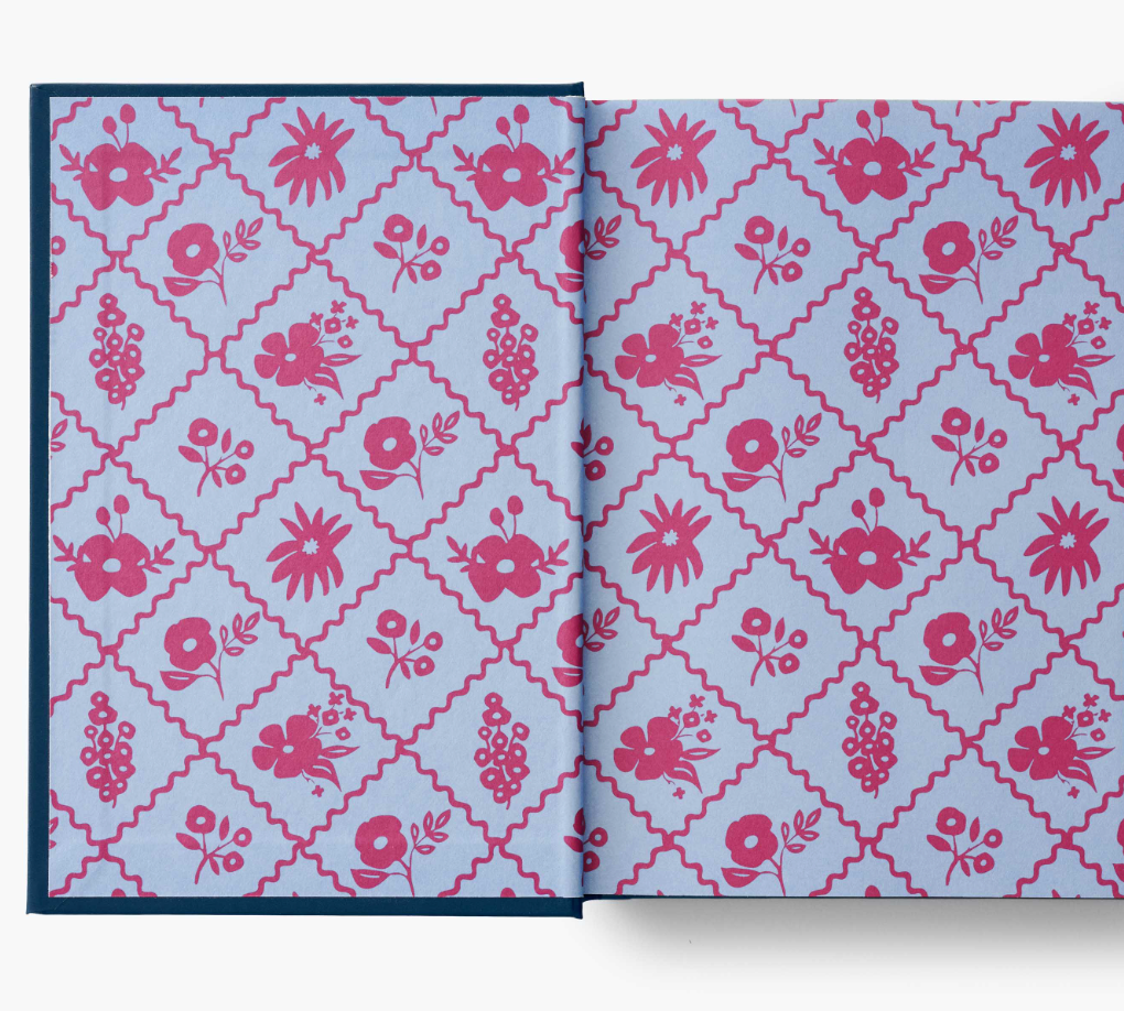 Interior cover of Puffin in Bloom Sense in Sensibility Book which features a blue diamond pattern and bright pink vector shaped flowers.