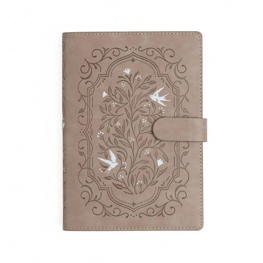 Brown leather notebook with embossed floral design and birds on a white background. Archer and Olive refillable Songbird deluxe system.