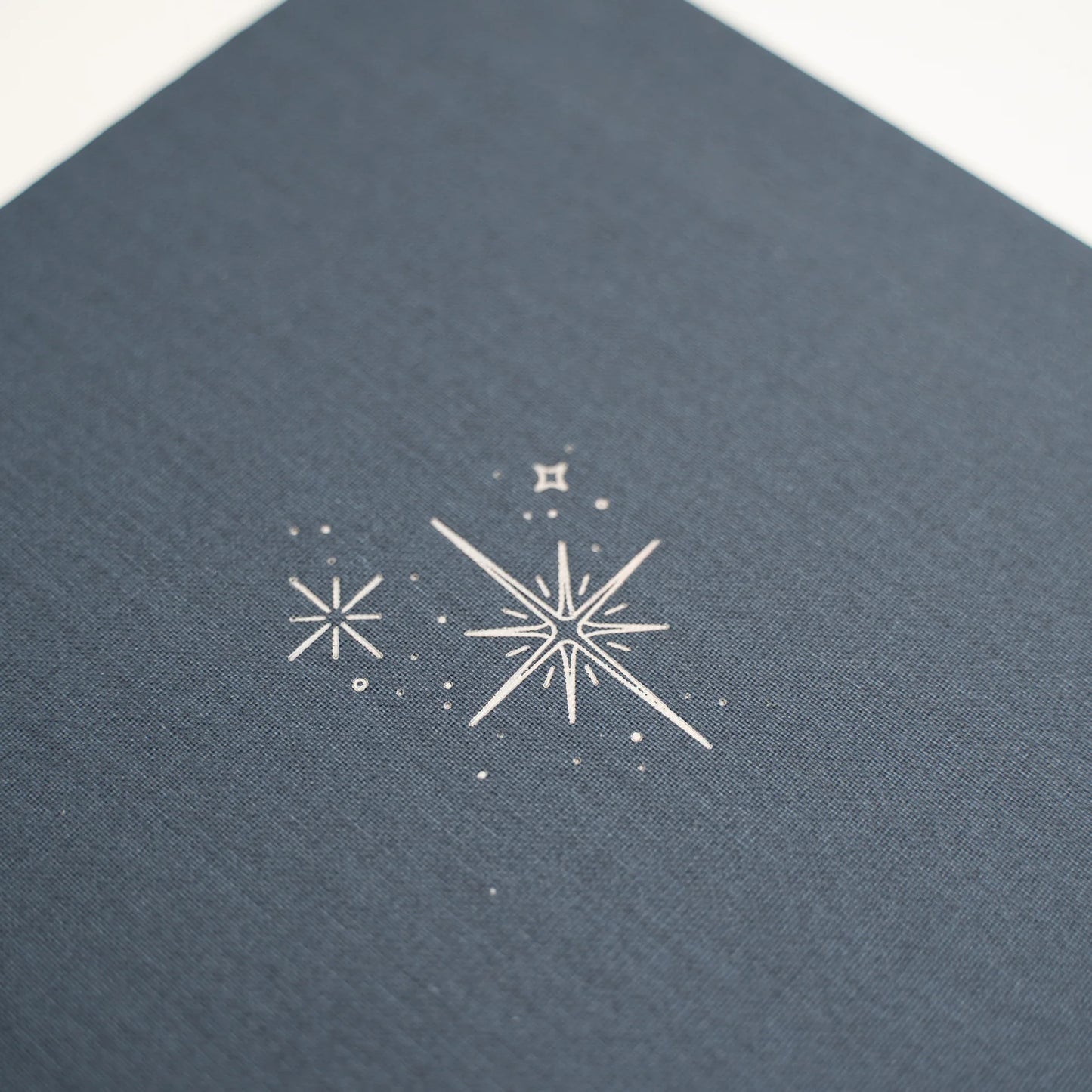 Archer and Olive Starbright Cover close up with decorative stars on a textured blue background