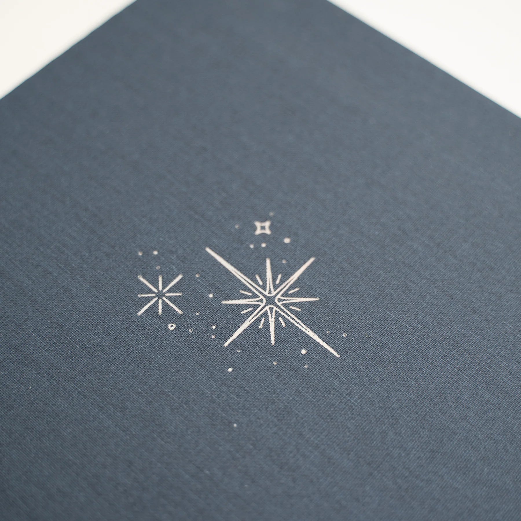 Archer and Olive Starbright Cover close up with decorative stars on a textured blue background