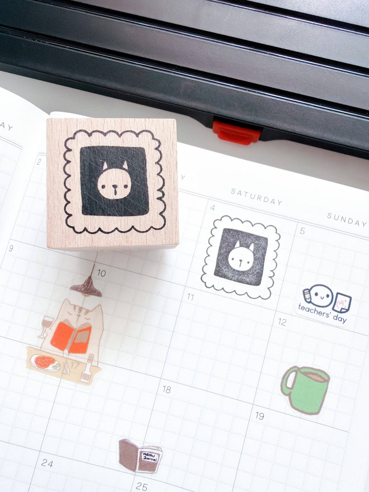 Rubber stamp with a cat design on a calendar page