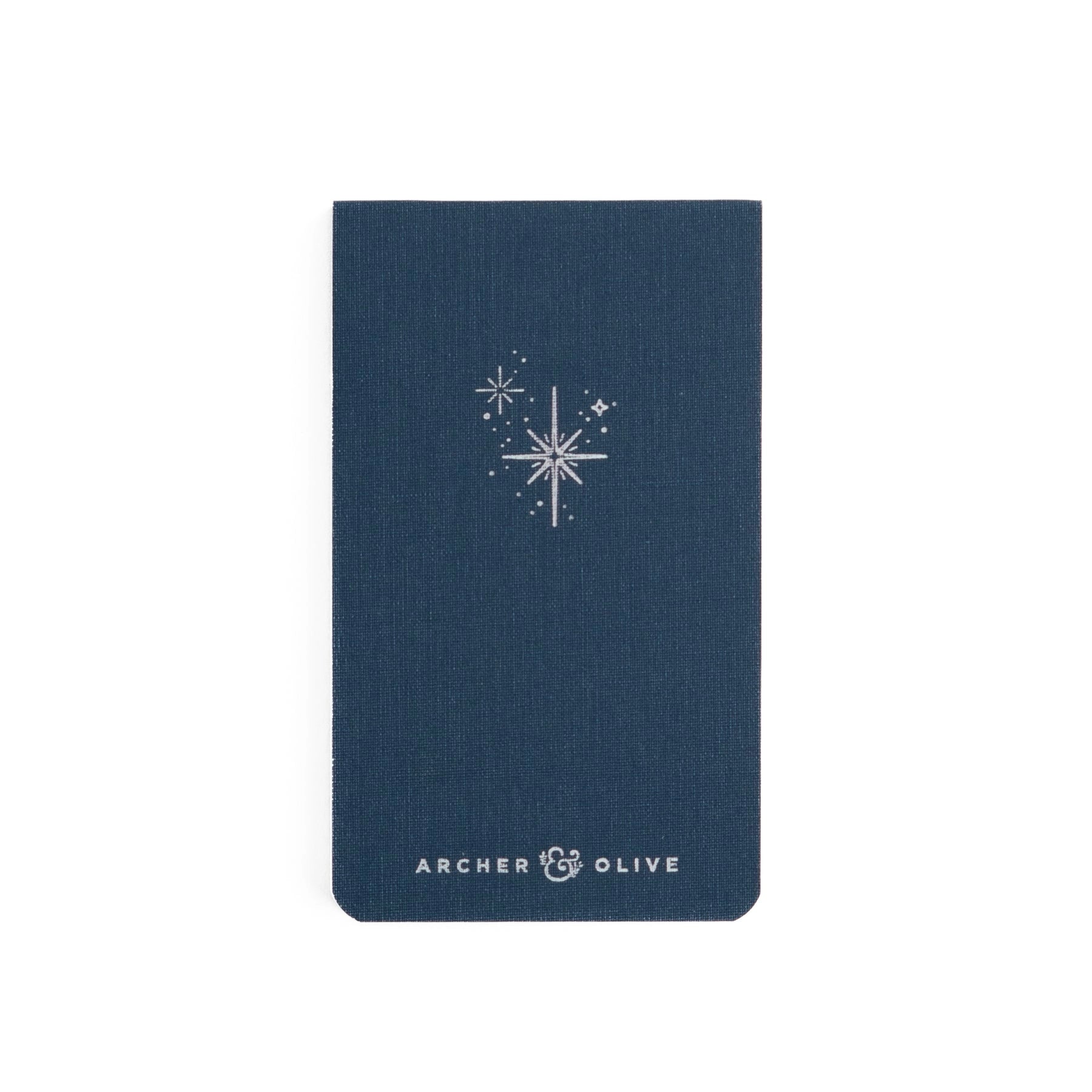 Small memo denim blue notebook with sparkle star design and Archer and Olive branding debossed in silver.