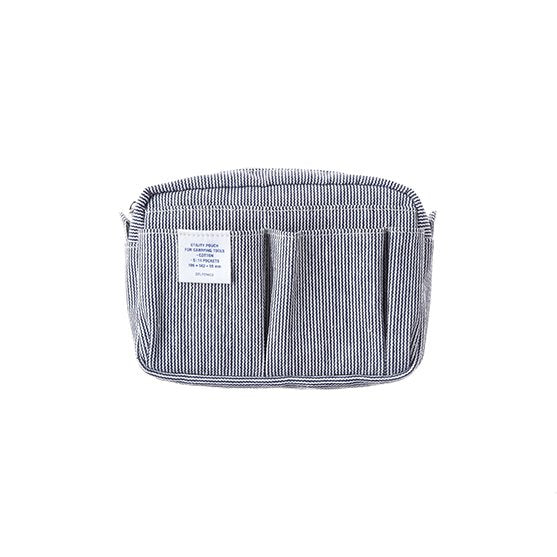 Striped fabric pouch with a Delfonics brand label on a white background. The front of the pouch has several pockets.